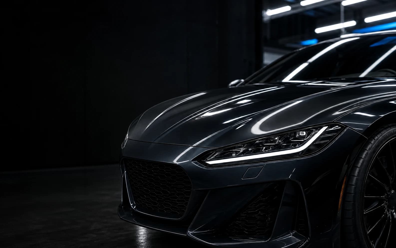 Graphite vehicle in a professional automotive installation bay
